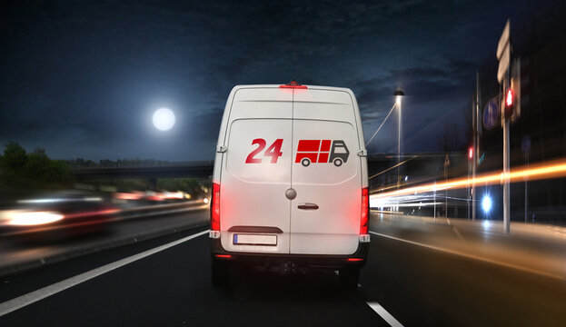 Christmas parcel delivery service by night on the road.
