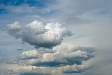 blue sky with dark blue, gray and white clouds with background texture