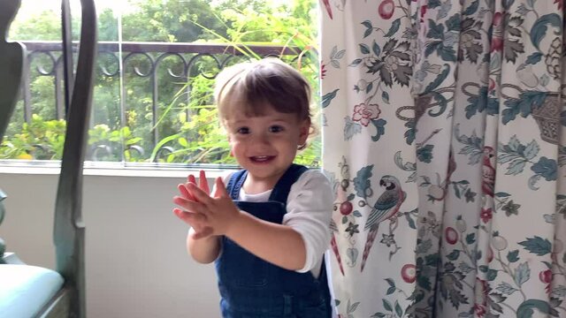 Adorable baby clapping hands, excited happy toddler claps