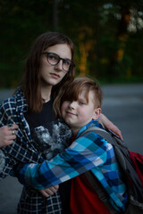 My brother hugs his older sister in nature