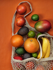 Trendy  ecological string bag with  tropical fruits:mango,avocado,bananas,orange,grapefruit.