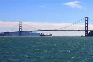A transport ship crossing the famous Golden Gate Bridge, San Francisco, California, USA 