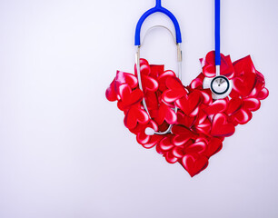 Blue doctor stethoscope Placed on many red hearts Light pink background with copy space concept happy valentine
