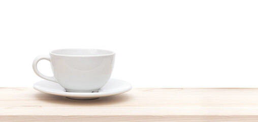 Fototapeta na wymiar White ceramic cup or mug on wooden table in front of white background, space for text