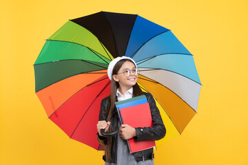 happy teen girl under colorful umbrella in autumn season hold notebook, autumn mood.