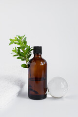 jar of brown color with a green sprig on a white isolated background. Organic, natural cosmetic. Beauty, skincare concept. Spa products