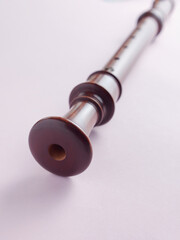 baroque recorder or flute isolated on light background