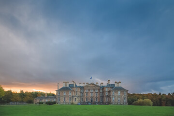 Fototapeta na wymiar A dark, moody ominous sunset sky over the historic Dalkeith Palace manor in Dalkeith Country Park, Edinburgh, Scotland.