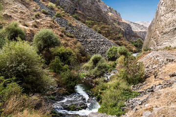 Fototapeta na wymiar View of the picturesque gorge of Garni along the Azat River with rocks in the form of basalt columns in the Kotayk region. Armenia