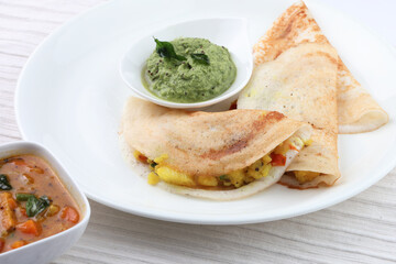 masala dosa with coconut chutney and mint chutney.
South Indian food.