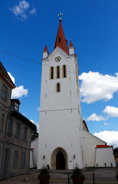 Medieval church of St. John on a background of blue sky with clouds in the old town of Cesis, Latvia