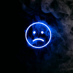 Stylized face expressing emotion glows through the stream of smoke in the dark