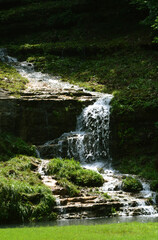 Fototapeta na wymiar A beautiful waterfall in a stream