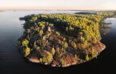 unknown medieval Swedish watchtower at cliff of small uninhabited island. Drone view in Vyborg bay, gulf of Finland.