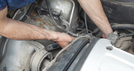 Mechanic repairs car engine. Car maintenance