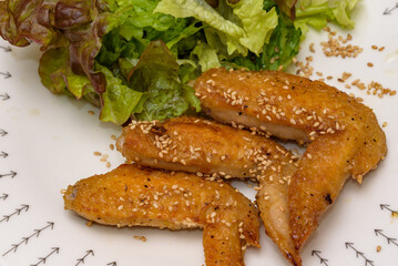 Grilled chicken wings with sweet and spicy sauce with sunny lettuce