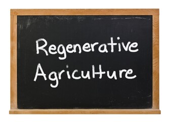 Regenerative agriculture written in white chalk on a black chalkboard isolated on white