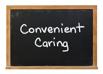 Obraz premium Convenient caring written in white chalk on a black chalkboard isolated on white