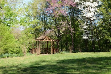 The wood gazebo structure in the park on a sunny day.
