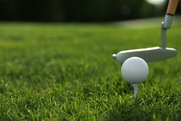 Hitting golf ball with club on green course, closeup. Space for text