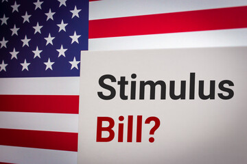 Conceptual keyword Stimulus Bill? on card on US flag background. Business, economy, social concept...