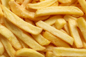 Yummy French fries as background, closeup view