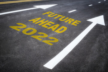 New year 2022 road to future ahead word on asphalt road with white arrow. Business challenge to recovery concept and success idea