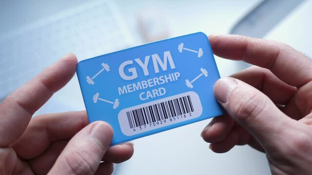 Holding a GYM membership card in the hands.