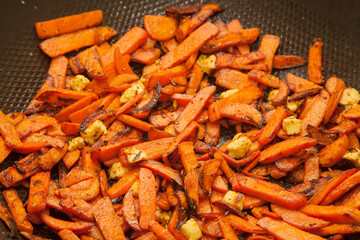 Closeup of frying carrots with paneer and selective focus