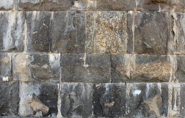 Textured dirty dolomite surface of river embankment