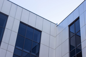 Fototapeta na wymiar Modern office building against the sky. Facade of a business building. Office building windows.