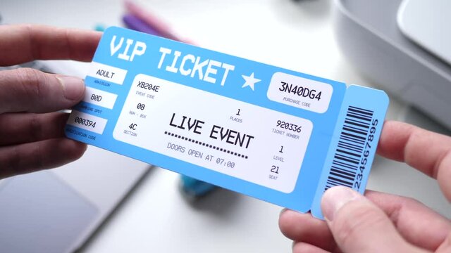 Hands holding a VIP Ticket for a live event. Closeup shot of the ticket