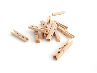 Set of wooden clothespins on white background. Close up of Pile of small wooden clip. Home accessories.