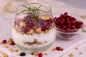 Dessert with cream cheese with granola and pomegranate.	
