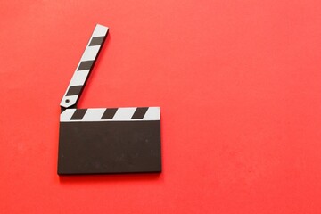 Movie clapper isolated on red background. Top view. Entertainment industry. Space for text.