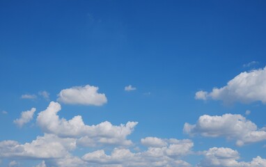 Naklejka na ściany i meble Blue sky background with white clouds on natural daylight background