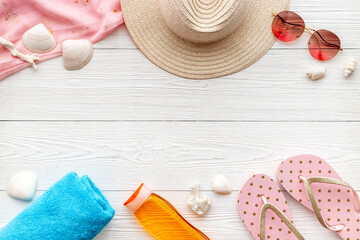 Summer holiday background with beach hat and flip flops. Top view