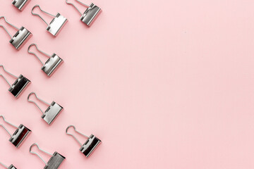 Office supplies background - paper binder clips top view