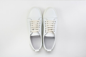White pair of sneakers on a white background. View from above. 