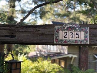 Welcome sign on inviting house in woods