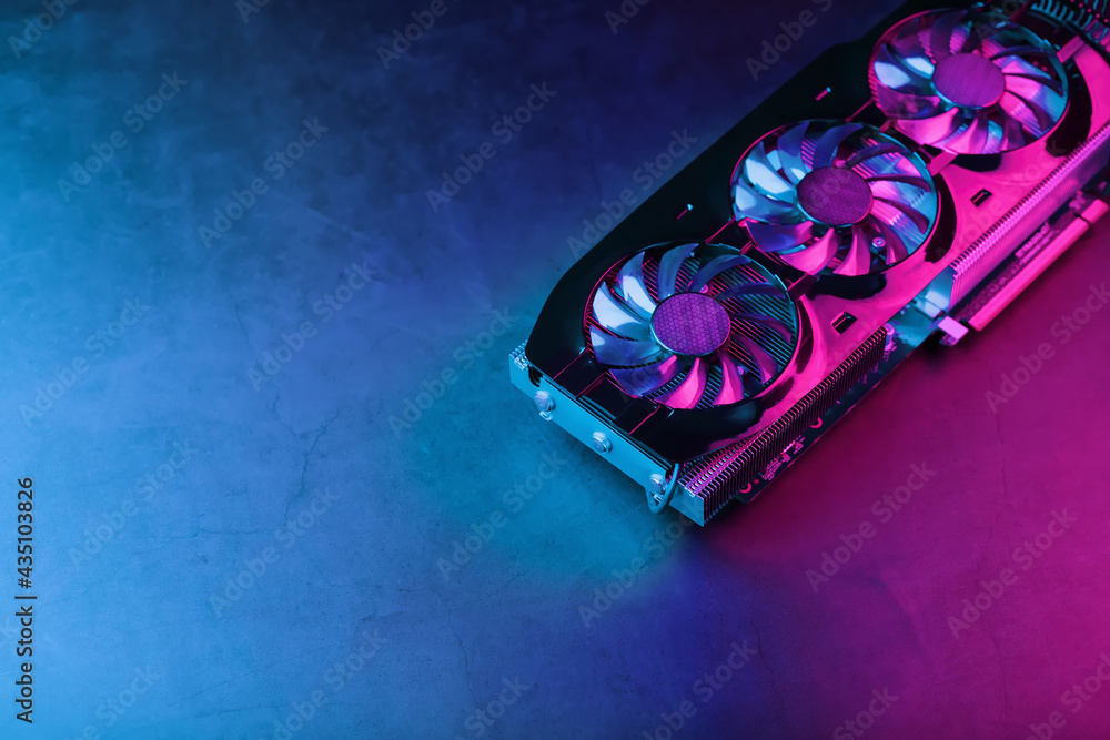 Fototapete A graphics card with a row of fans with a cyanotic purple backlight in a futuristic design.