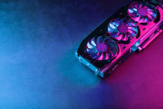 A graphics card with a row of fans with a cyanotic purple backlight in a futuristic design.