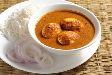 egg curry with rice and onion. Indian lunch
