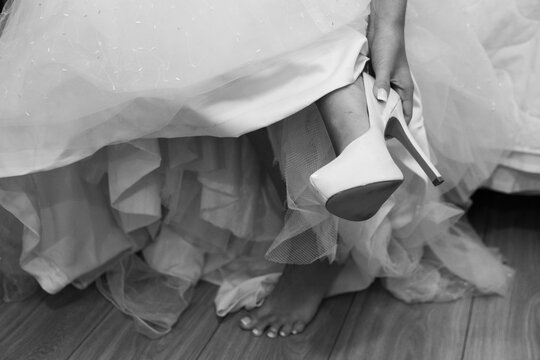 Bride Taking Off Her High Heels