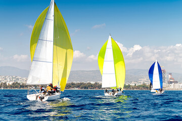 Three sport sailing boats during the regatta - obrazy, fototapety, plakaty
