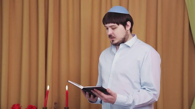 Before the chuppah ceremony, the Jewish groom reads siddur prayers in the synagogue hall