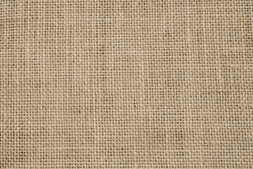 Hessian sackcloth burlap woven texture background, Cotton woven fabric close up with flecks of varying colors of beige and brown, with copy space for text decoration.