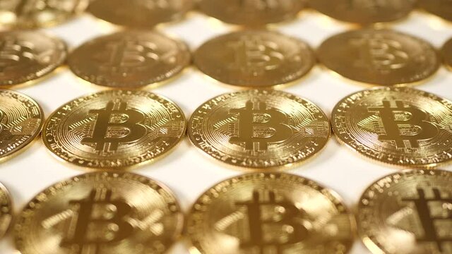 Golden bitcoins, horizontal pattern of coins.