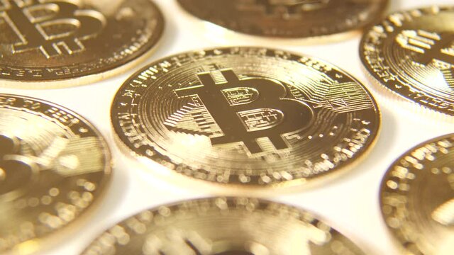 Golden bitcoin in bright light, close up. 