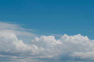 Fototapeta na wymiar Aerial view on moody thunder clouds flying on horizon under blue sky 